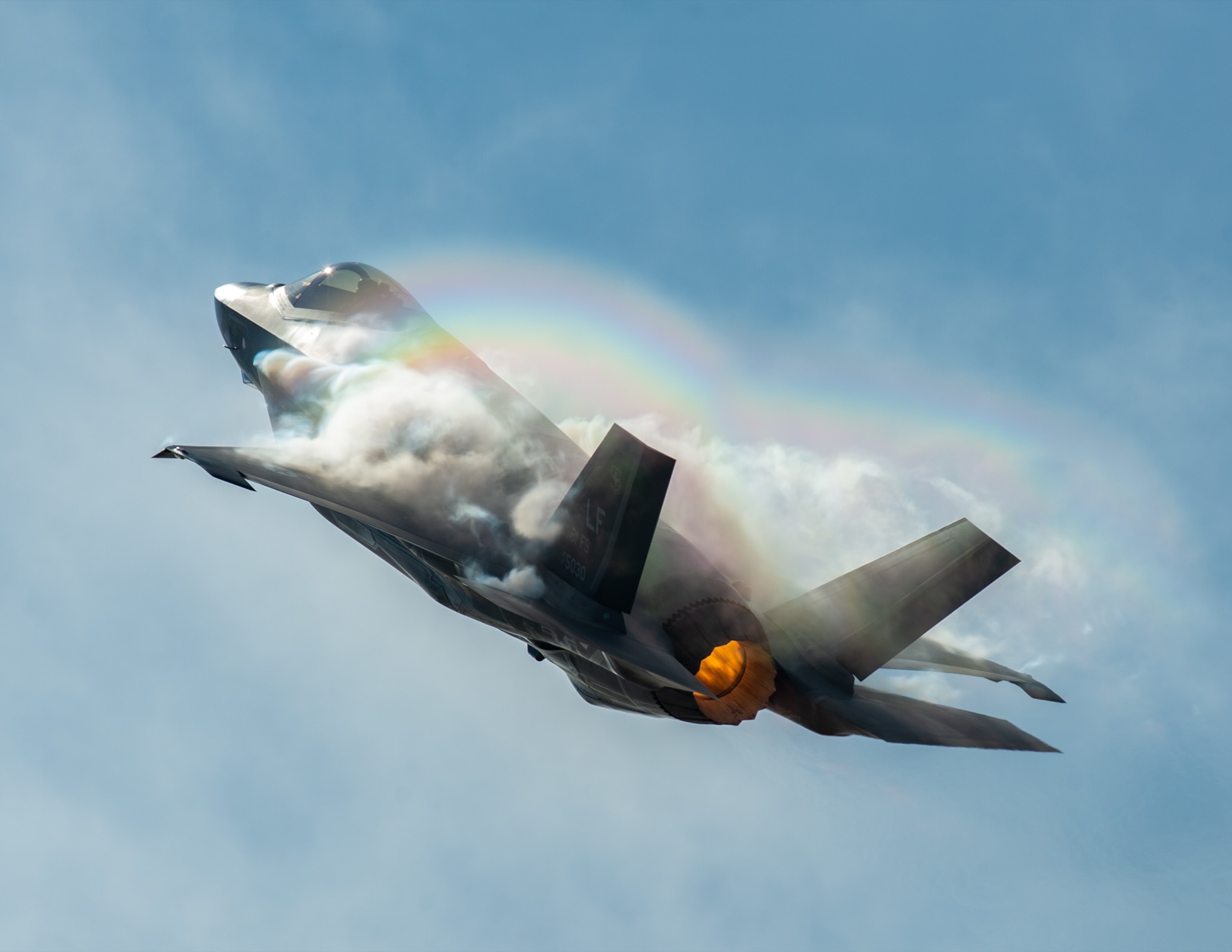 F-35A in a vertical climb with afterburner and vapor cone